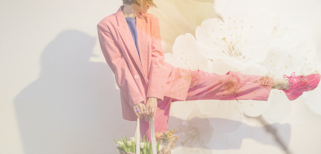 Woman wearing pink suit and flowers in bag - Tru Blue Boutique