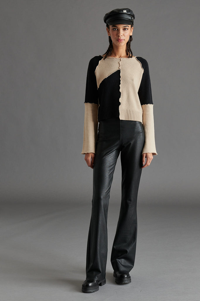 A two-toned aysmmetrical black and cream sweater by Steve Madden at Tru Blue Boutique