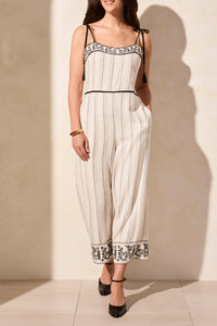 A cream colored jumpsuit with black embroidery detail - Tru Blue Boutique