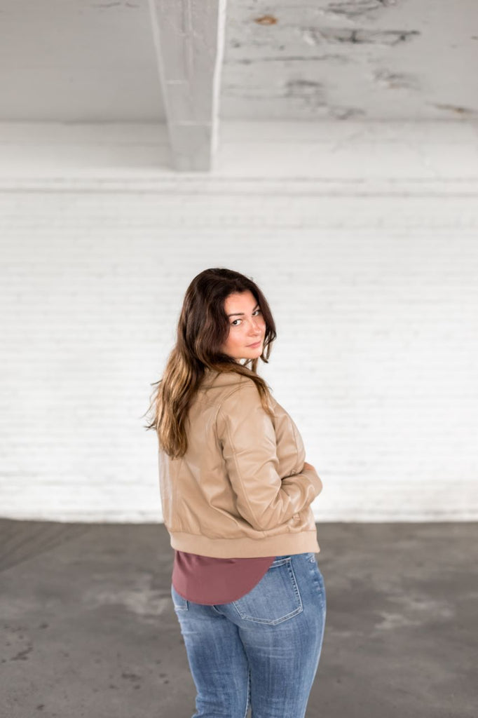 Coats, jackets, blazers. Here is a tan vegan leather bomber jacket at Tru Blue Boutique