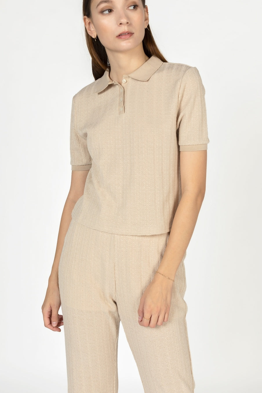 This light-weight knit polo top by Mod Ref features a partial button-front placket  in taupe at Tru Blue Boutique