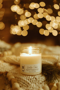 Clean burning soy wax candle in winter cabin scent of Fraser Fir, Sandalwood, and Citrus in 6.5 oz glass jar.