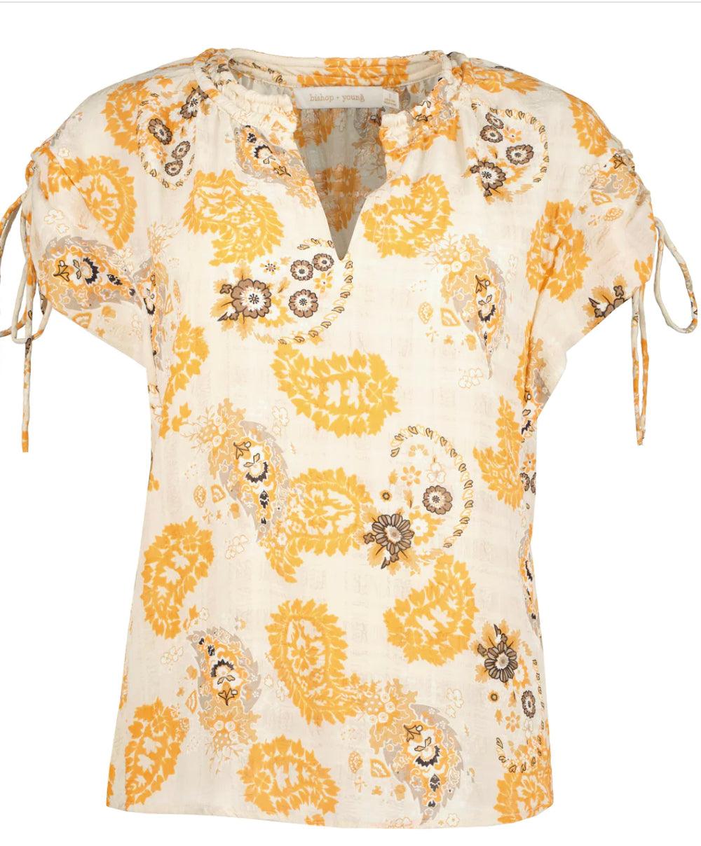 Luna Blouse - Tru Blue  Montecito print top is a band collar, v-neckline with tie at the sleeves. The pop of yellow and neutral paisley
