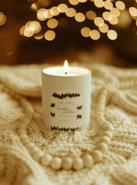Clean burning soy wax candle in Sweater Weather, containing scents of Oakmoss, Amber, and Vetiver in 12 oz ceramic tumbler.